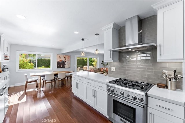 1780 N Mockingbird Pl, Orange, CA 92867 - kitchen with high end stove, wall chimney range hood, decorative backsplash, light countertops, and white cabinets