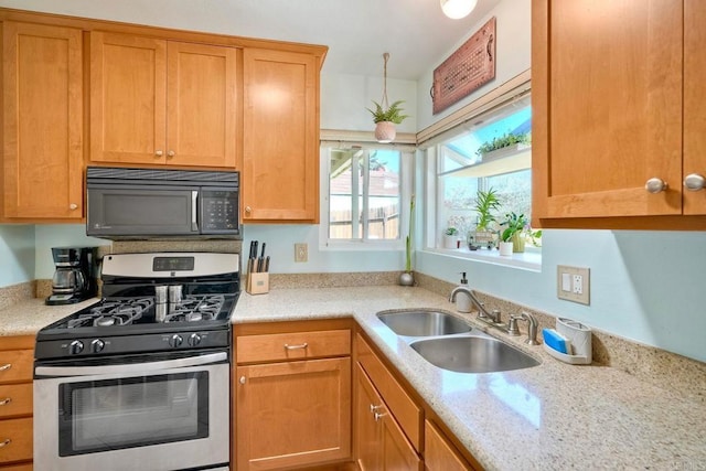 826 Laurelwood Ct, San Marcos, CA 92069 - kitchen with black microwave, stainless steel range with gas cooktop, and light stone countertops