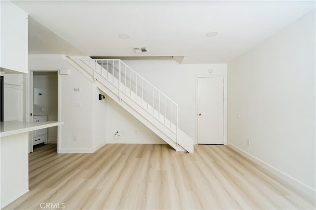 1438 W 146th St Unit 6, Gardena, CA 90247 - unfurnished living room featuring stairs and light wood-type flooring