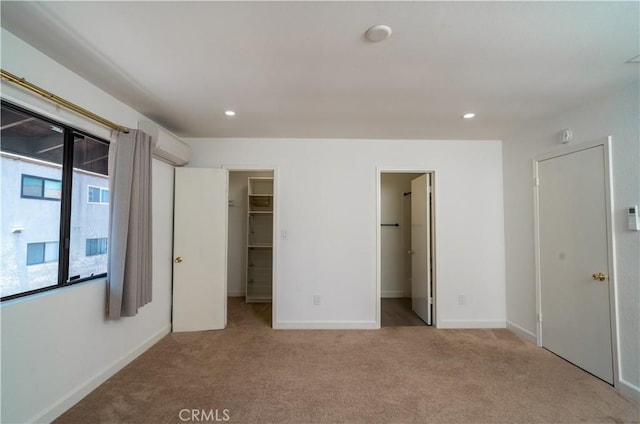 1438 W 146th St Unit 6, Gardena, CA 90247 - unfurnished bedroom with a spacious closet, an AC wall unit, carpet floors, recessed lighting, and a closet