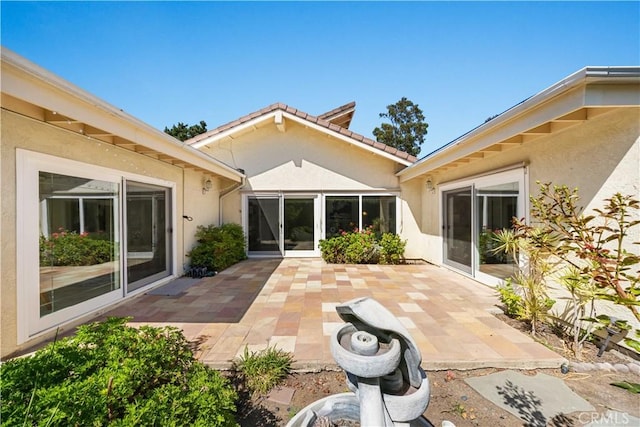 18701 Paseo Cortez, Irvine, CA 92603 - rear view of house featuring stucco siding and a patio area