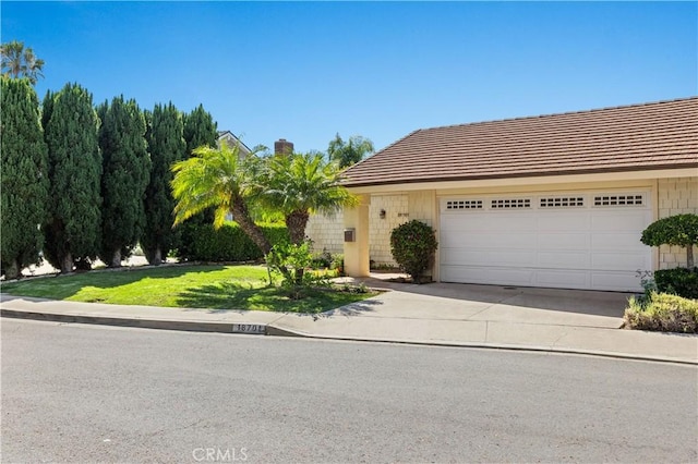 18701 Paseo Cortez, Irvine, CA 92603 - view of front of home with driveway, an attached garage, a front yard, and a chimney