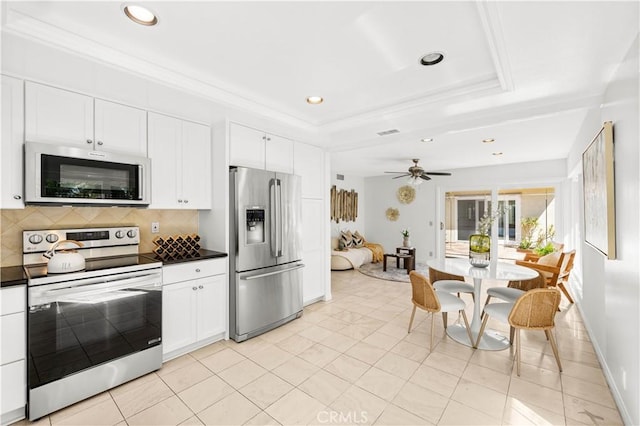 18701 Paseo Cortez, Irvine, CA 92603 - kitchen featuring stainless steel appliances, dark countertops, decorative backsplash, white cabinetry, and recessed lighting