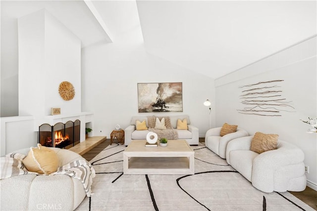 18701 Paseo Cortez, Irvine, CA 92603 - living room with vaulted ceiling, light wood-style flooring, and a warm lit fireplace