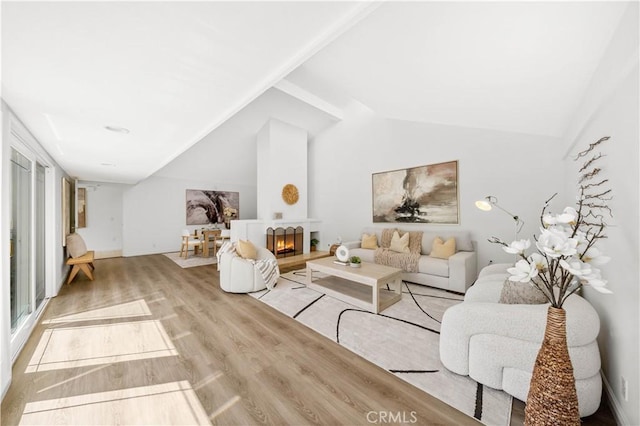 18701 Paseo Cortez, Irvine, CA 92603 - living area featuring vaulted ceiling, wood finished floors, and a warm lit fireplace