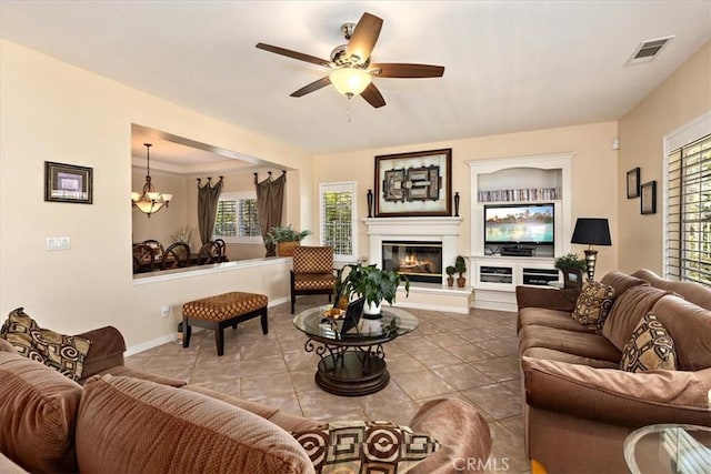 12487 Altura Dr, Rancho Cucamonga, CA 91739 - tiled living room featuring ceiling fan, plenty of natural light, a glass covered fireplace, and a chandelier