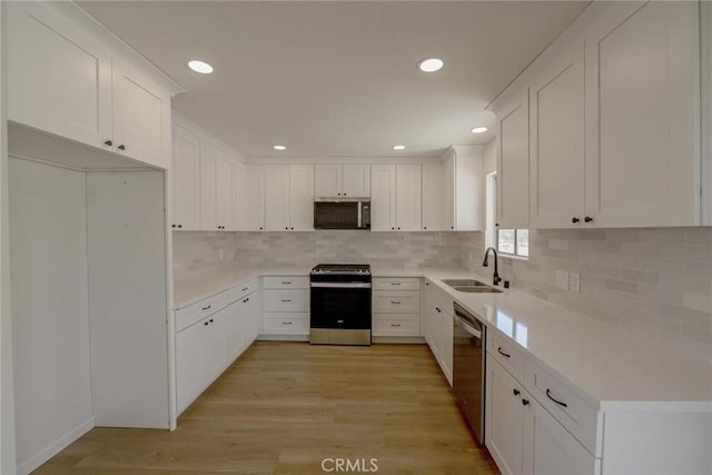 27825 Beryl Rd, Barstow, CA 92311 - kitchen with appliances with stainless steel finishes, white cabinetry, tasteful backsplash, and recessed lighting