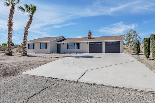 27825 Beryl Rd, Barstow, CA 92311 - ranch-style home with stucco siding, an attached garage, a chimney, and concrete driveway