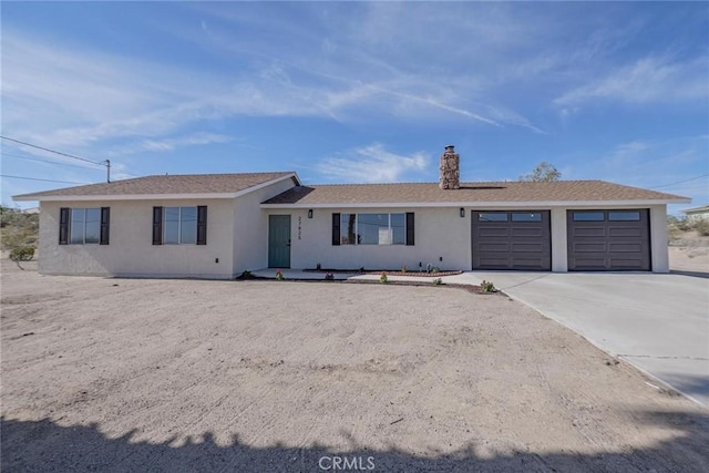 27825 Beryl Rd, Barstow, CA 92311 - single story home with stucco siding, a garage, driveway, and a chimney