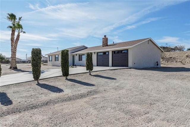 27825 Beryl Rd, Barstow, CA 92311 - single story home with a garage, a chimney, driveway, and stucco siding