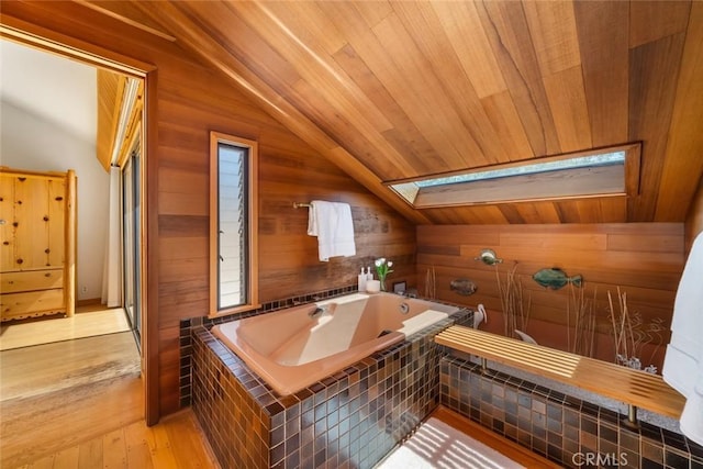 1505 Tiffany Ranch Rd, Arroyo Grande, CA 93420 - bathroom featuring lofted ceiling, a skylight, wooden walls, a bath, and wood finished floors