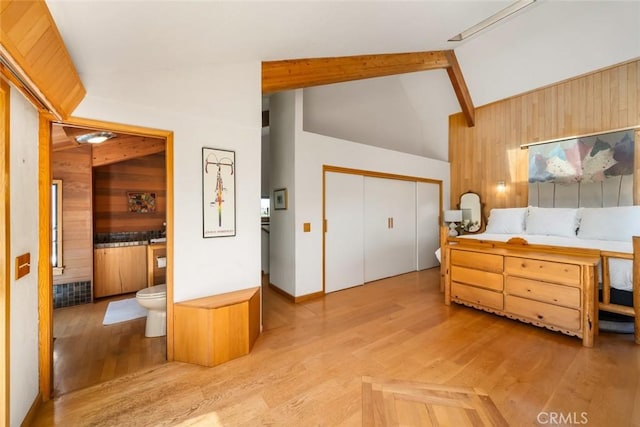 1505 Tiffany Ranch Rd, Arroyo Grande, CA 93420 - bedroom with wooden walls, light wood finished floors, a closet, and ensuite bathroom