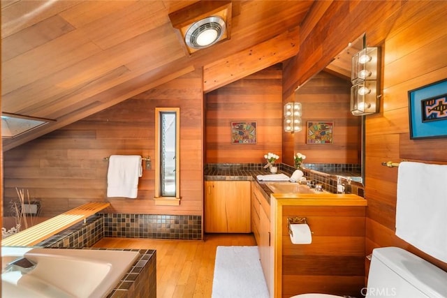1505 Tiffany Ranch Rd, Arroyo Grande, CA 93420 - full bath with vaulted ceiling, wood walls, vanity, hardwood / wood-style floors, and a relaxing tiled tub