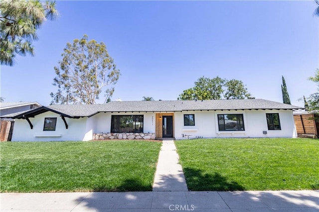 20611 Devonshire St, Chatsworth, CA 91311 - view of front facade featuring stucco siding and a front lawn