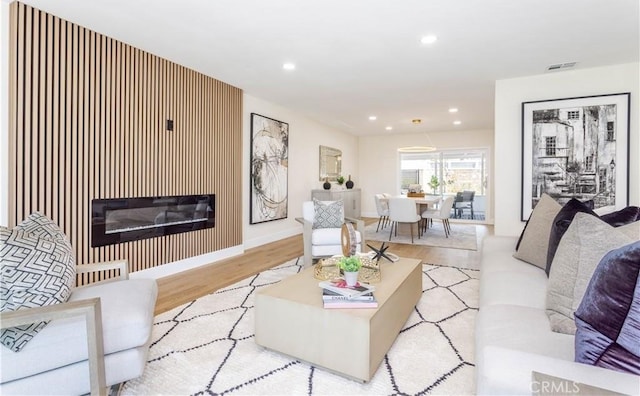 20611 Devonshire St, Chatsworth, CA 91311 - living room featuring light wood-type flooring, recessed lighting, and a glass covered fireplace
