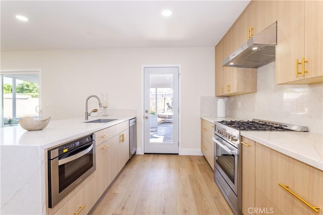 20611 Devonshire St, Chatsworth, CA 91311 - kitchen with stainless steel appliances, under cabinet range hood, light brown cabinetry, a peninsula, and light wood-style floors