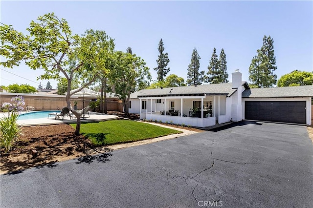 20611 Devonshire St, Chatsworth, CA 91311 - ranch-style house with an attached garage, a chimney, asphalt driveway, and stucco siding