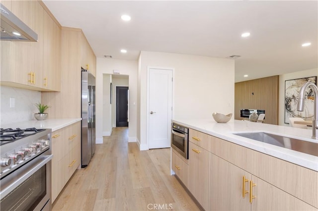 20611 Devonshire St, Chatsworth, CA 91311 - kitchen with light brown cabinetry, range hood, appliances with stainless steel finishes, modern cabinets, and recessed lighting