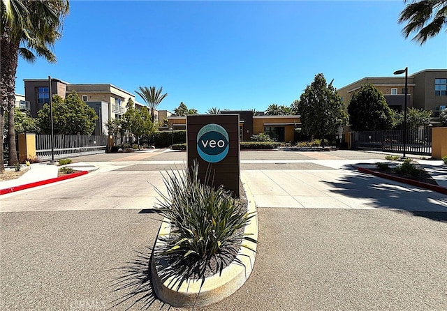 612 E Carson St Unit 303, Carson, CA 90745 - view of asphalt road featuring sidewalks, curbs, street lighting, and a residential view