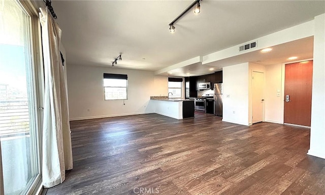 612 E Carson St Unit 303, Carson, CA 90745 - unfurnished living room featuring rail lighting and dark wood-style flooring