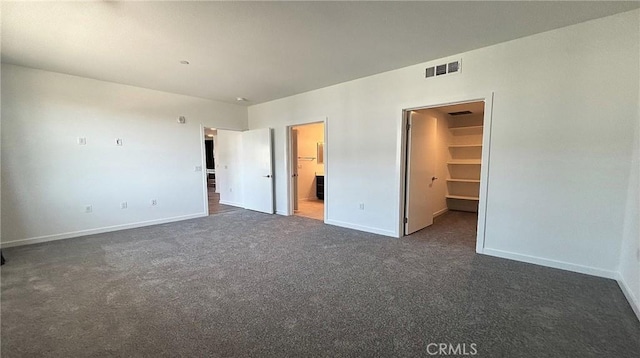 612 E Carson St Unit 303, Carson, CA 90745 - unfurnished bedroom featuring carpet flooring, a walk in closet, and ensuite bath