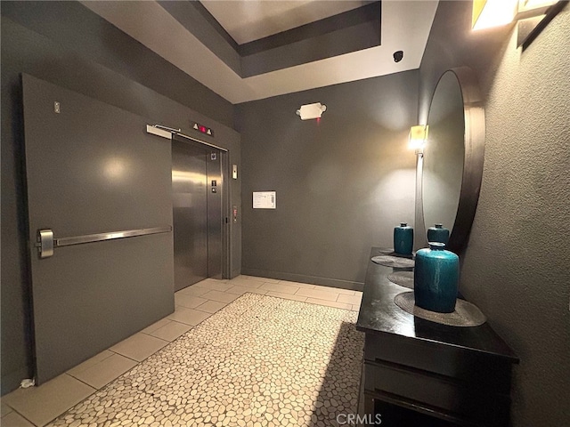 612 E Carson St Unit 303, Carson, CA 90745 - hall with elevator, light tile patterned floors, and a tray ceiling