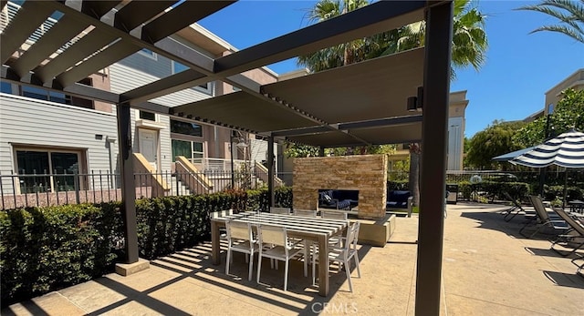 612 E Carson St Unit 303, Carson, CA 90745 - view of patio / terrace featuring an outdoor stone fireplace and outdoor dining space