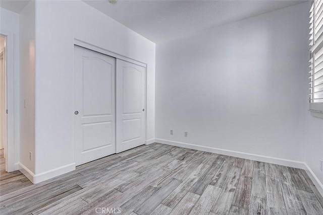 5410 W 149th Pl Unit 12, Hawthorne, CA 90250 - unfurnished bedroom with light wood-type flooring and a closet