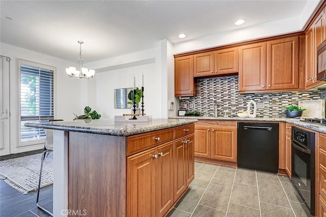 5410 W 149th Pl Unit 12, Hawthorne, CA 90250 - kitchen with black appliances, a kitchen island, a chandelier, light stone countertops, and backsplash