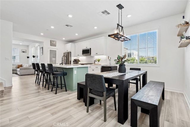10 Wisteria St, Rancho Mission Viejo, CA 92694 - dining room with light wood finished floors, recessed lighting, and a chandelier