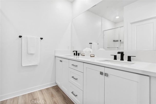 10 Wisteria St, Rancho Mission Viejo, CA 92694 - bathroom with double vanity, a shower stall, and wood finished floors