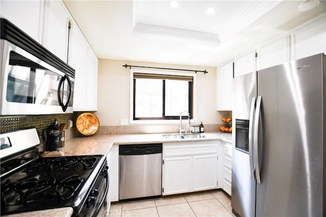3093 Brea Blvd Unit 16, Fullerton, CA 92835 - kitchen with appliances with stainless steel finishes, a raised ceiling, light tile patterned floors, white cabinetry, and ornamental molding