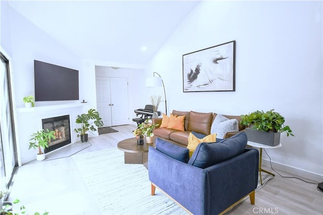 3093 Brea Blvd Unit 16, Fullerton, CA 92835 - living room featuring lofted ceiling, a fireplace with flush hearth, and wood finished floors