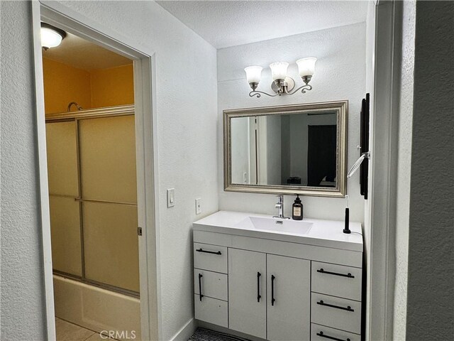 3093 Brea Blvd Unit 16, Fullerton, CA 92835 - full bath with vanity, enclosed tub / shower combo, a textured wall, and tile patterned floors