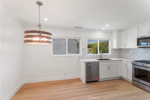 72 Eagle Unit 38, Irvine, CA 92604 - kitchen with appliances with stainless steel finishes, backsplash, white cabinetry, light wood finished floors, and recessed lighting