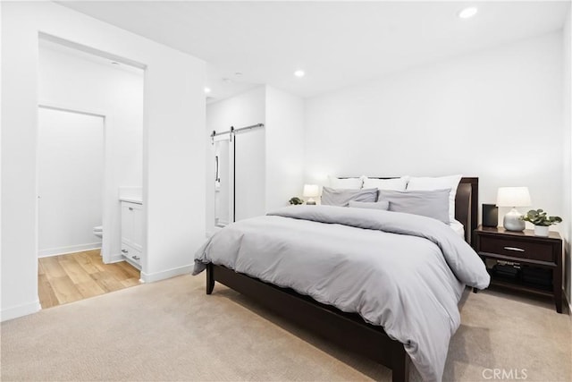 112 Juniper Dr, Rancho Mission Viejo, CA 92694 - bedroom featuring light colored carpet, a barn door, recessed lighting, and connected bathroom