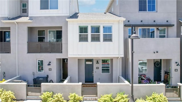 112 Juniper Dr, Rancho Mission Viejo, CA 92694 - multi unit property featuring a fenced front yard, board and batten siding, stucco siding, and a gate