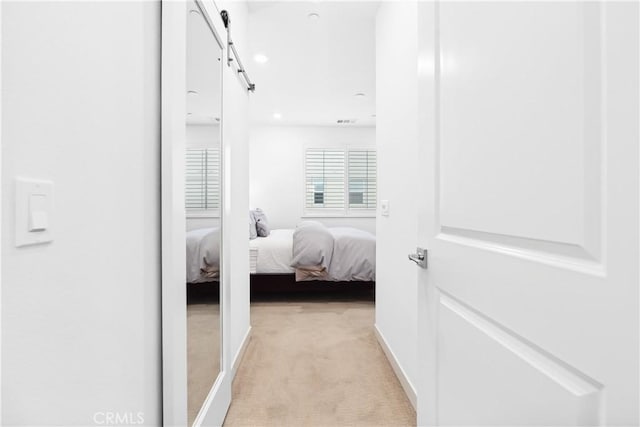 112 Juniper Dr, Rancho Mission Viejo, CA 92694 - hallway with a barn door and light carpet