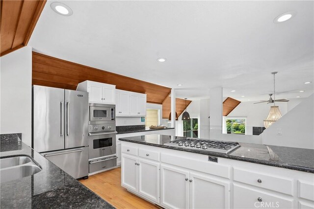 390 Saint Anns Dr, Laguna Beach, CA 92651 - kitchen featuring stainless steel appliances, a warming drawer, dark stone counters, white cabinets, and recessed lighting