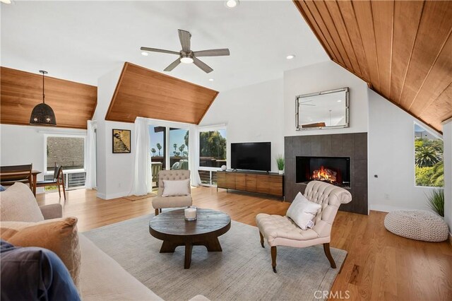 390 Saint Anns Dr, Laguna Beach, CA 92651 - living area featuring vaulted ceiling, ceiling fan, a tile fireplace, light wood-style floors, and wood ceiling