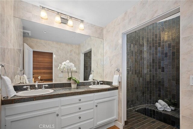 390 Saint Anns Dr, Laguna Beach, CA 92651 - bathroom with tile walls, double vanity, and walk in shower