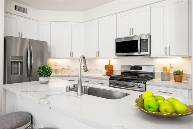 17 Marseille Way, Lake Forest, CA 92610 - kitchen featuring stainless steel appliances, white cabinetry, and light stone countertops