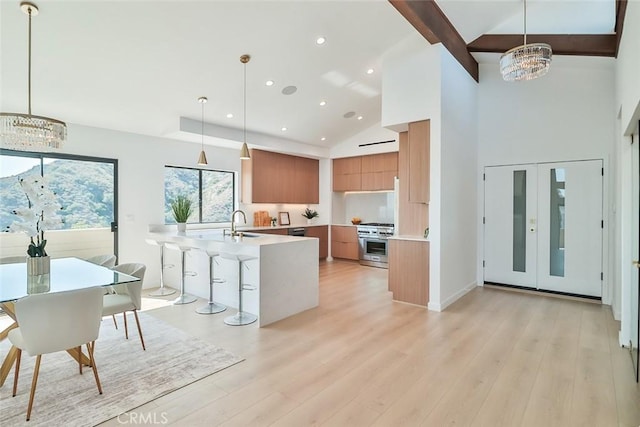 1369 Paseo Redondo, Burbank, CA 91501 - kitchen with a chandelier, modern cabinets, brown cabinetry, stainless steel range, and light countertops