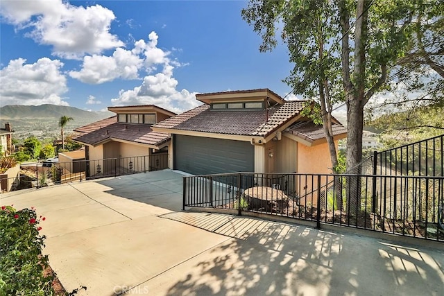 1369 Paseo Redondo, Burbank, CA 91501 - view of front of house with a tiled roof, concrete driveway, stucco siding, a garage, and a mountain view
