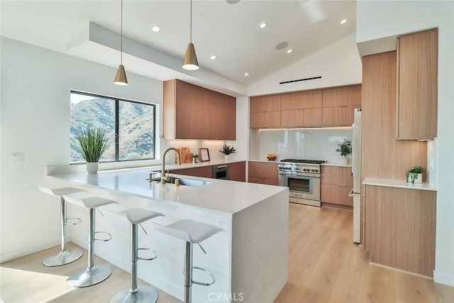 1369 Paseo Redondo, Burbank, CA 91501 - kitchen featuring stainless steel stove, modern cabinets, a peninsula, a kitchen bar, and light countertops
