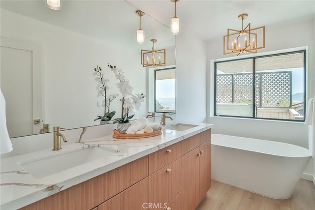 1369 Paseo Redondo, Burbank, CA 91501 - bathroom with a chandelier, a soaking tub, wood finished floors, and double vanity