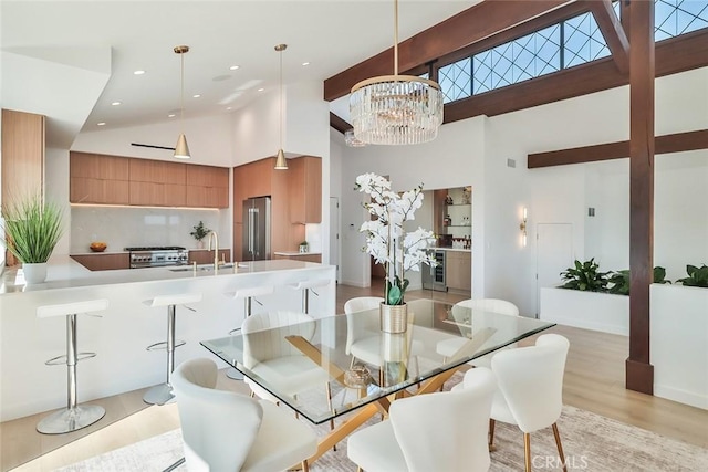 1369 Paseo Redondo, Burbank, CA 91501 - dining area with high vaulted ceiling, beverage cooler, light wood finished floors, a chandelier, and recessed lighting
