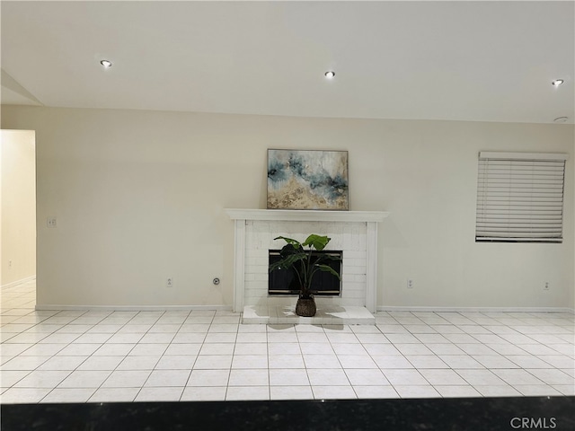 1350 William Mcgrath St, Colton, CA 92324 - unfurnished living room with a brick fireplace, light tile patterned floors, and recessed lighting