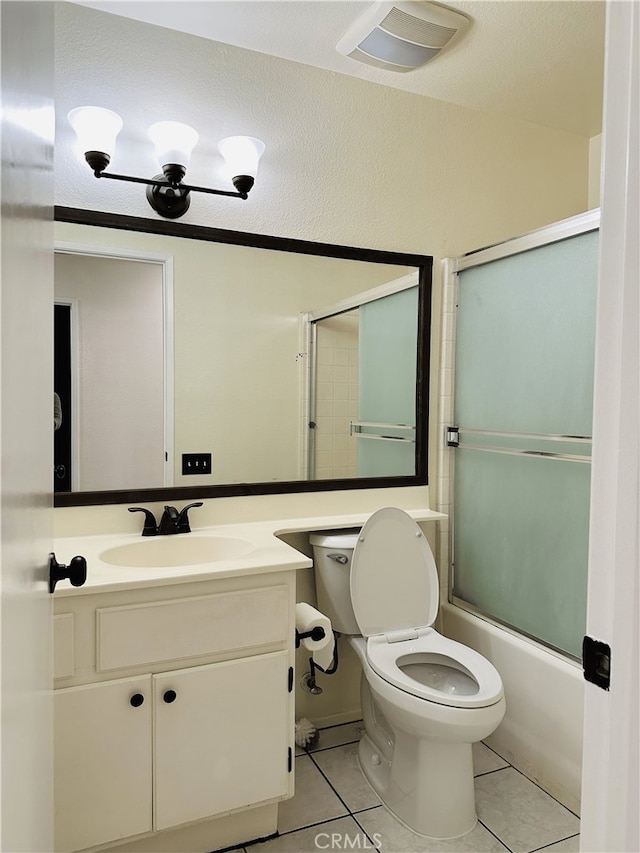 1350 William Mcgrath St, Colton, CA 92324 - bathroom featuring tile patterned floors, vanity, and combined bath / shower with glass door