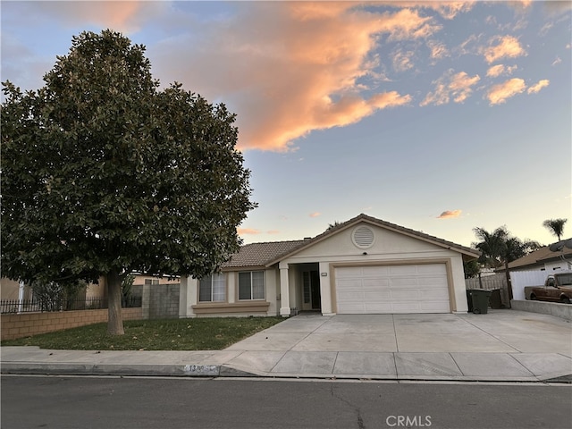 1350 William Mcgrath St, Colton, CA 92324 - single story home featuring a garage, concrete driveway, stucco siding, and a tile roof
